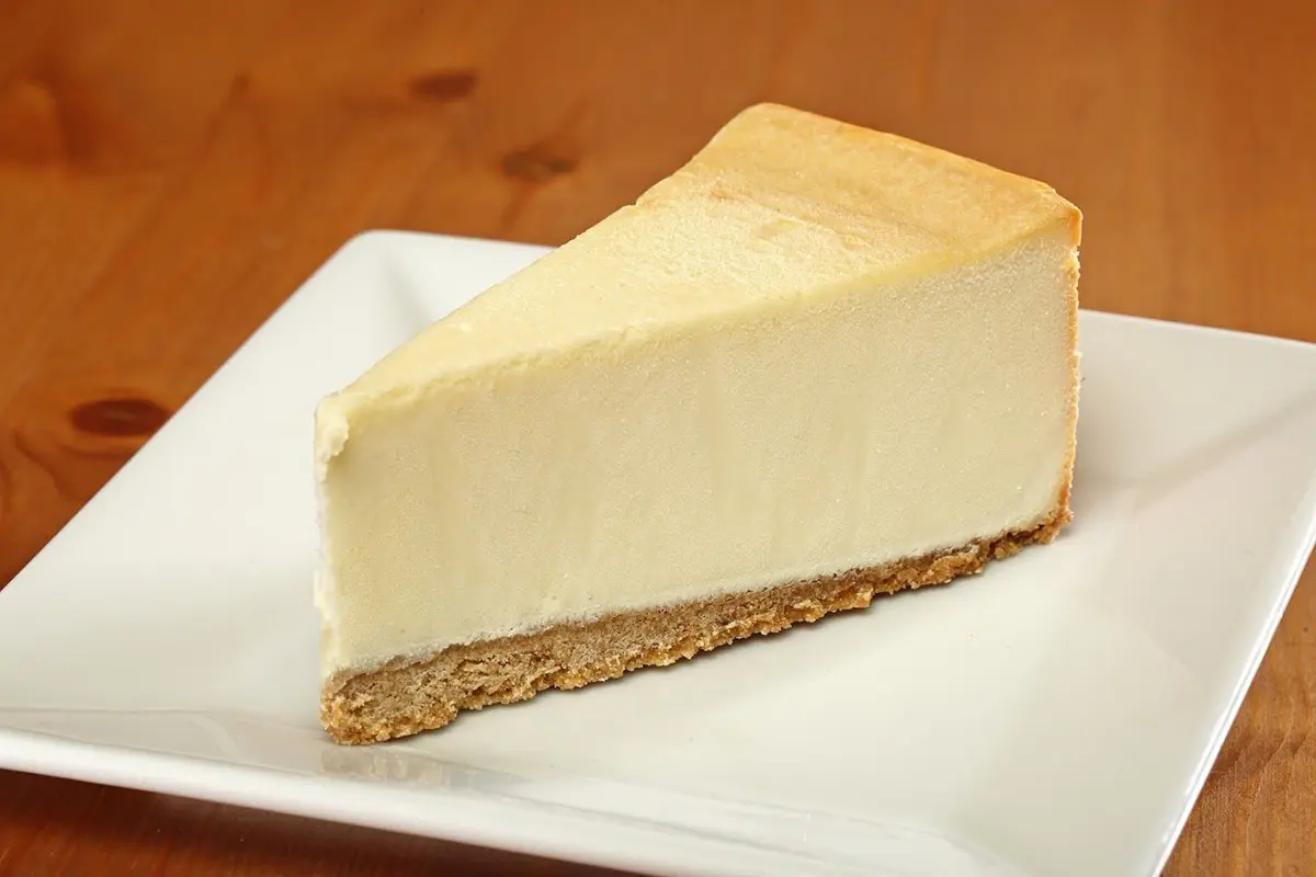 A piece of cheesecake on top of a white plate.