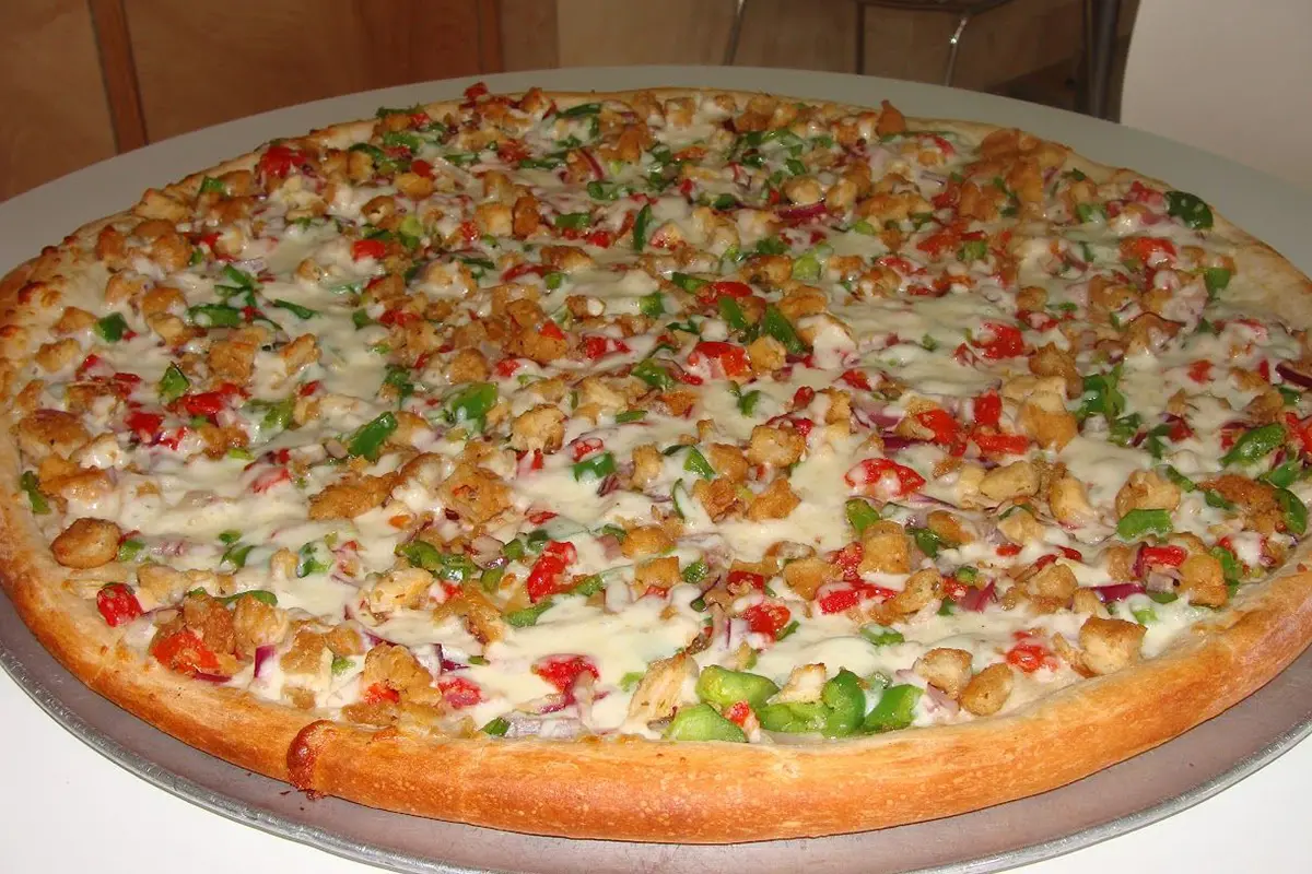 A pizza with many toppings on it