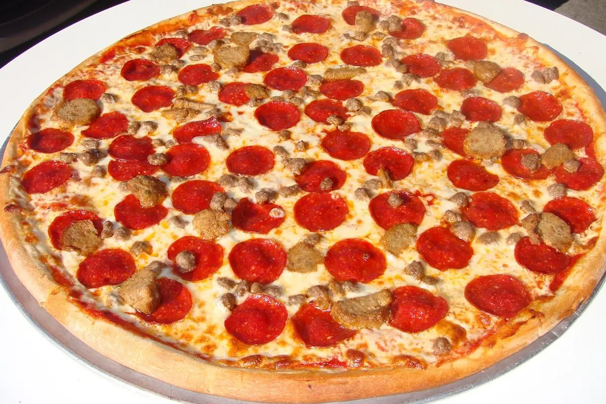 A pepperoni pizza with mushrooms and other toppings.